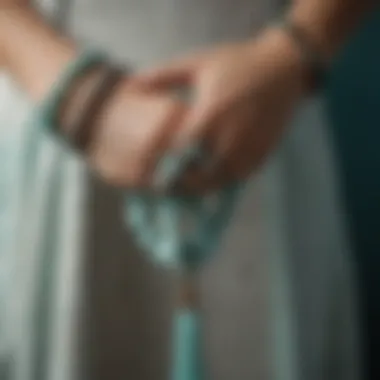 Graceful Amazonite Mala Display An elegant hand holding a string of amazonite mala, showcasing its beauty and craftsmanship