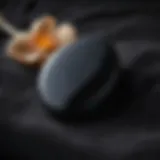Dark and mysterious black obsidian worry stone resting on a bed of soft velvet