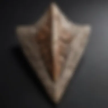 Close-up of an expertly crafted arrowhead with intricate designs