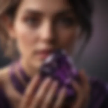 Person holding dark purple crystal, showcasing its beauty