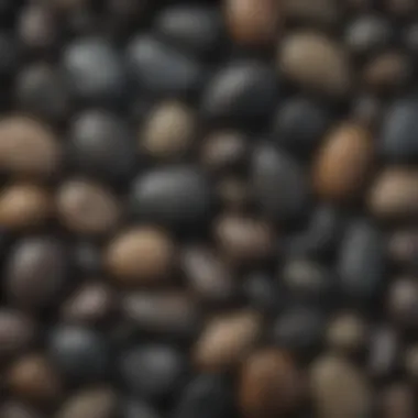 A collection of smooth black river rocks in various sizes and shapes.