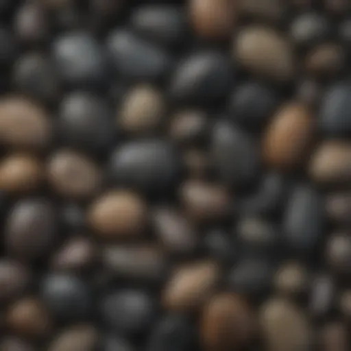 A collection of smooth black river rocks in various sizes and shapes.