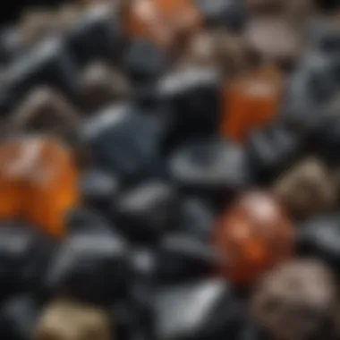 A collection display of various types of raw obsidian, emphasizing diversity