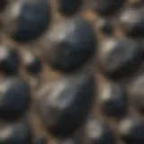 Close-up of a black rock with unique mineral patterns on a sandy beach