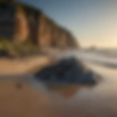 Erosion effects on beach landscape highlighting black rocks