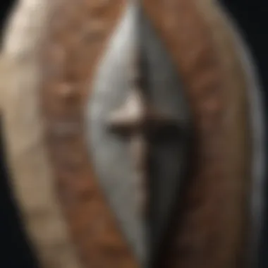Close-up view of a finely crafted flint arrowhead with intricate details.
