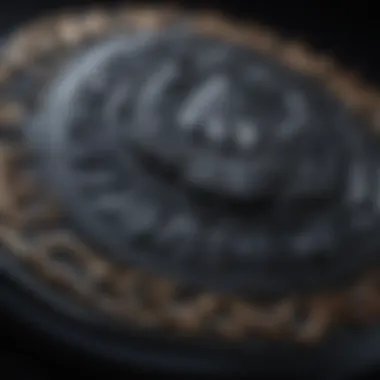 Close-up of intricate carvings on a black obsidian worry stone glistening in soft candlelight