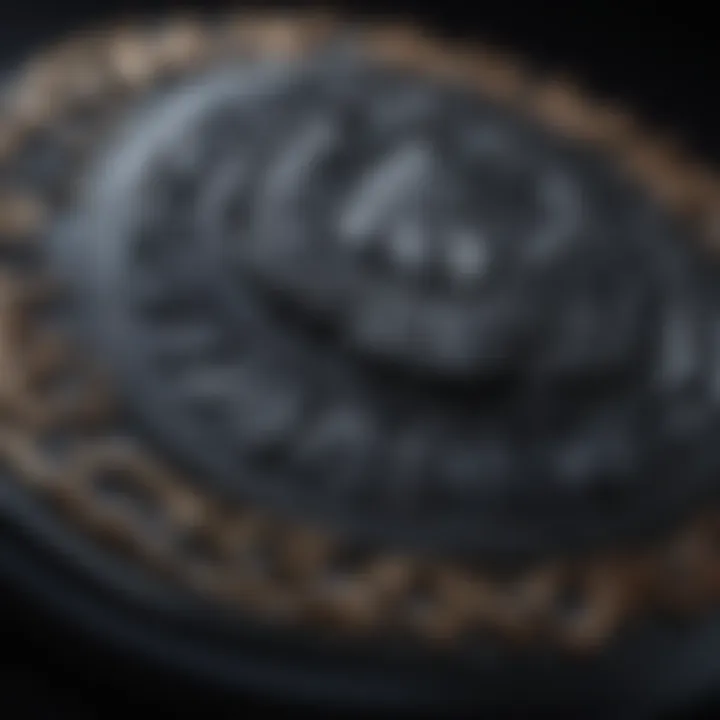 Close-up of intricate carvings on a black obsidian worry stone glistening in soft candlelight