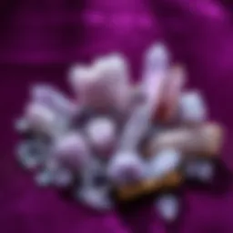 A collection of various light purple crystals on a velvet surface