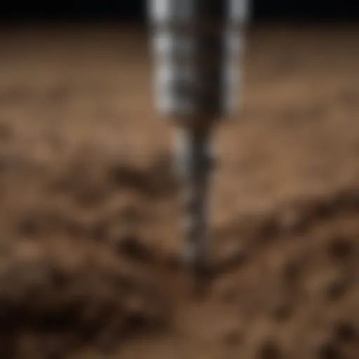 Precision carbide drill bit cutting through soil