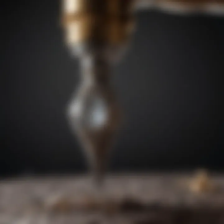 An artist using a diamond drill bit on a piece of jewelry
